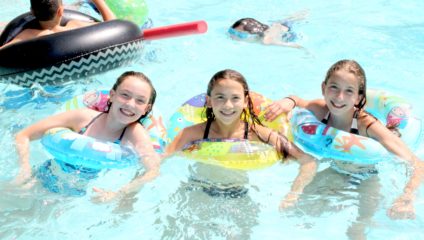 three girls swimming in pool