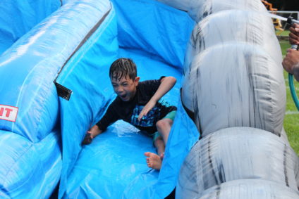 boy sliding down water slide